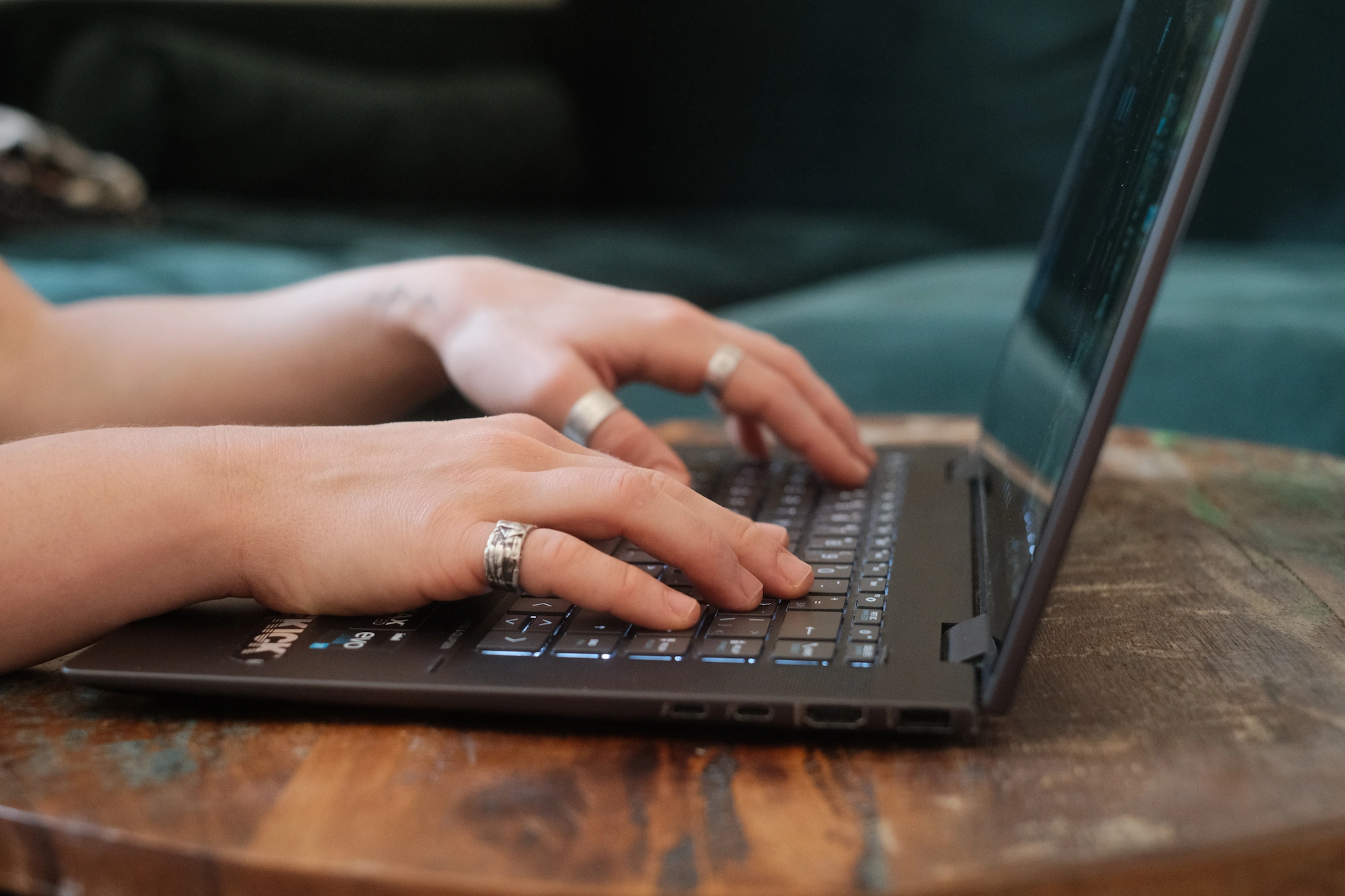 Close-up of hands typing on a laptop keyboard